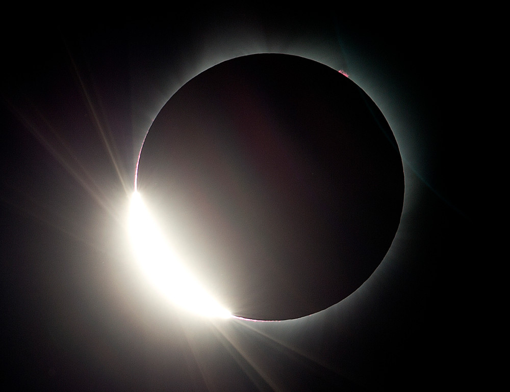 As the moon almost totally eclipses the sun, the diamond ring effect is seen during a total solar eclipse as seen from Salem, Ore., Monday, Aug. 21, 2017. Small reddish coloring on upper right side of the sun is a solar prominence. (AP Photo/Don Ryan)