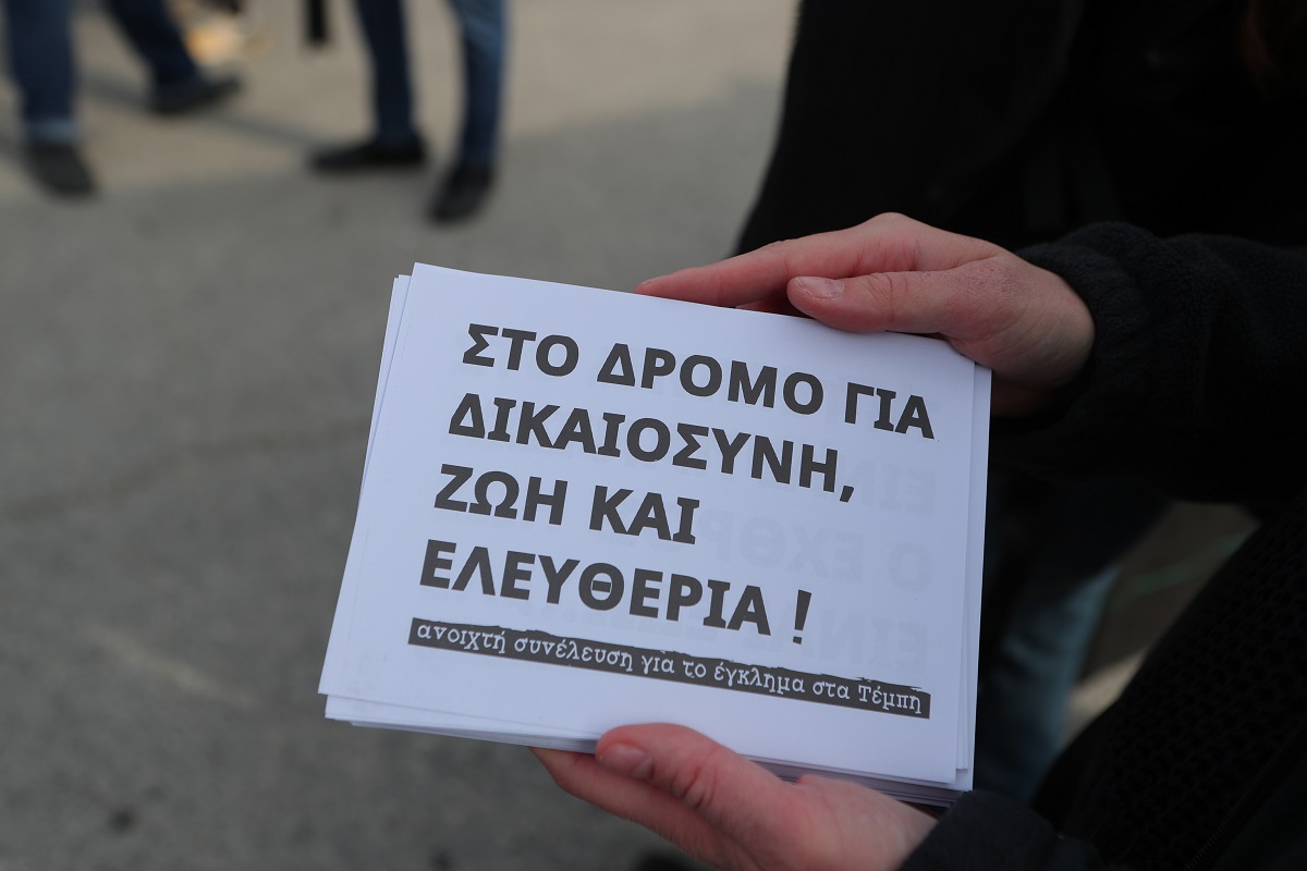 Συγκεντρώσεις έξω από το κτήριο του Συνεδριακού Κέντρου Πανεπιστημίου Θεσσαλίας που βρίσκεται στο συγκρότημα ΓΑΙΟΠΟΛΙΣ (πρώην ΤΕΙ Λάρισας) όπου διεξάγεται η δίκη για το σιδηροδρομικό δυστύχημα στα Τέμπη, που στοίχισε τη ζωή σε 57 ανθρώπους, κυρίως νέους ηλικίας 15 έως 25 ετών, στην Λάρισα, Δευτέρα 23 Μαρτίου 2026. Στο Τριμελές Εφετείο Κακουργημάτων παραπέμπονται 36 άτομα, ενώ οι μάρτυρες ξεπερνούν τους 350. Περισσότερα από 230 πρόσωπα - συγγενείς θυμάτων, επιζώντες και φορείς - θα παραστούν προς υποστήριξη της κατηγορίας. Οι 33 από τους κατηγορούμενους αντιμετωπίζουν βαριές κακουργηματικές κατηγορίες. Στο εδώλιο βρίσκονται στελέχη από όλο το φάσμα του σιδηροδρομικού συστήματος, συμπεριλαμβανομένων του ΟΣΕ, της ΕΡΓΟΣΕ, της ΡΑΣ, καθώς και της Hellenic Train. (ΣΩΤΗΡΗΣ ΔΗΜΗΤΡΟΠΟΥΛΟΣ/EUROKINISSI)